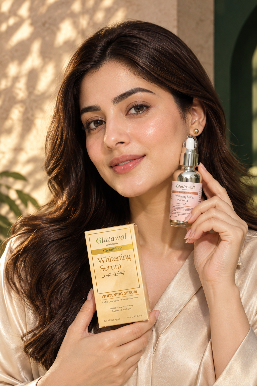 Way of Living Glutawol radiant beauty ambassador with luminous glass skin holding luxury cosmetic serum bottle